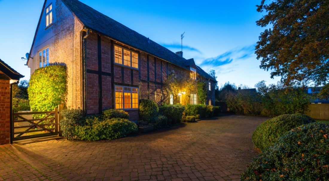 Image of Manor House in twighlight showing the outdoor lighting