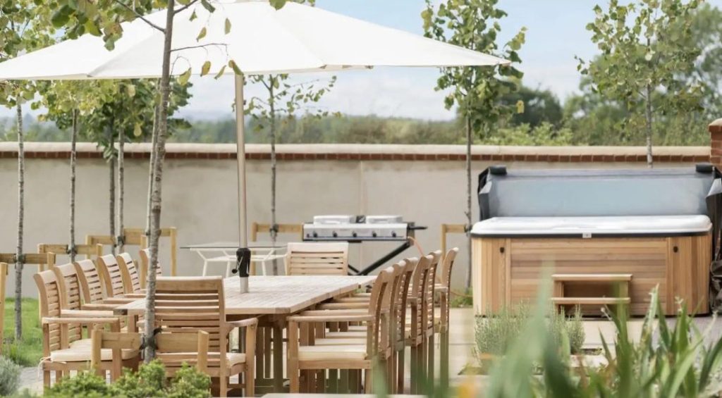 Luxurious outdoor kitchen and hot tub in one of our Cotswold holiday homes