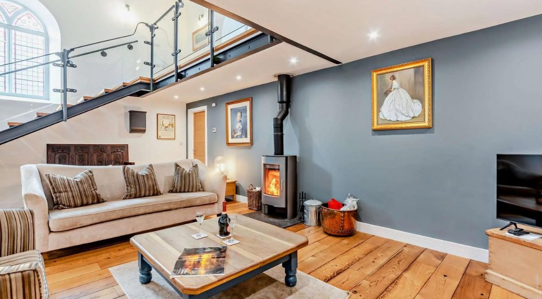 Open plan sitting room with wood burner