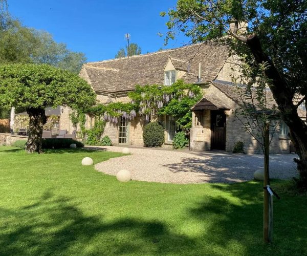 A stunning Cotswold home rental with a lush green lawn
