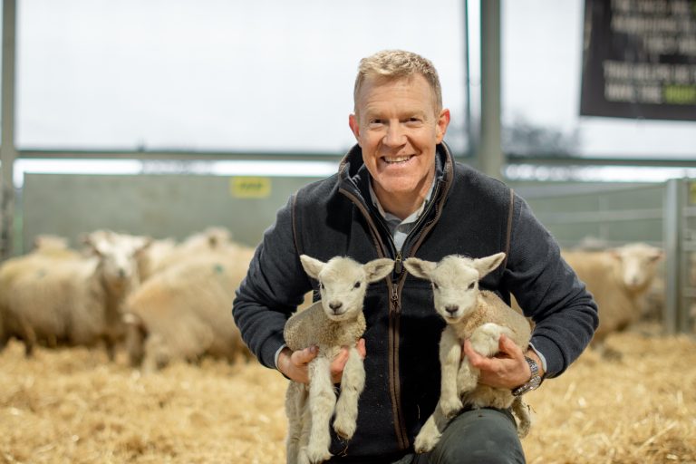 Adam Henson from Cotswold Farm Park with baby lambs in the shed