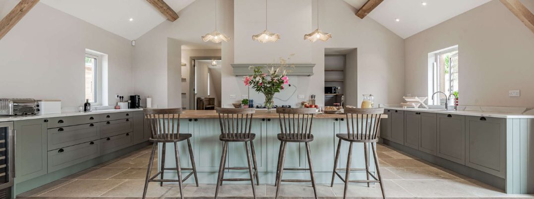 Beautiful country kitchen with high bar stools on the kitchen island