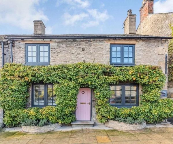 Pink front door on a Cotswold cottage