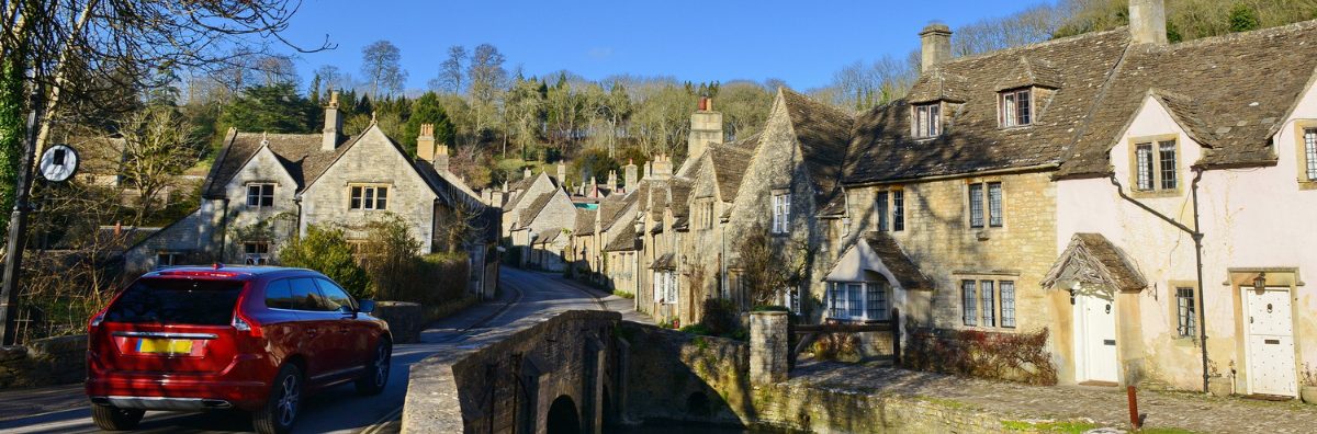Driving to the Cotswolds Car driving over a stone bridge in the Cotswolds