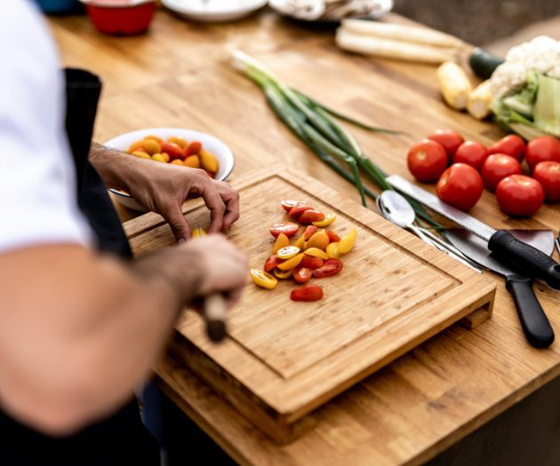 private chef chopping vegetables on a chopping board